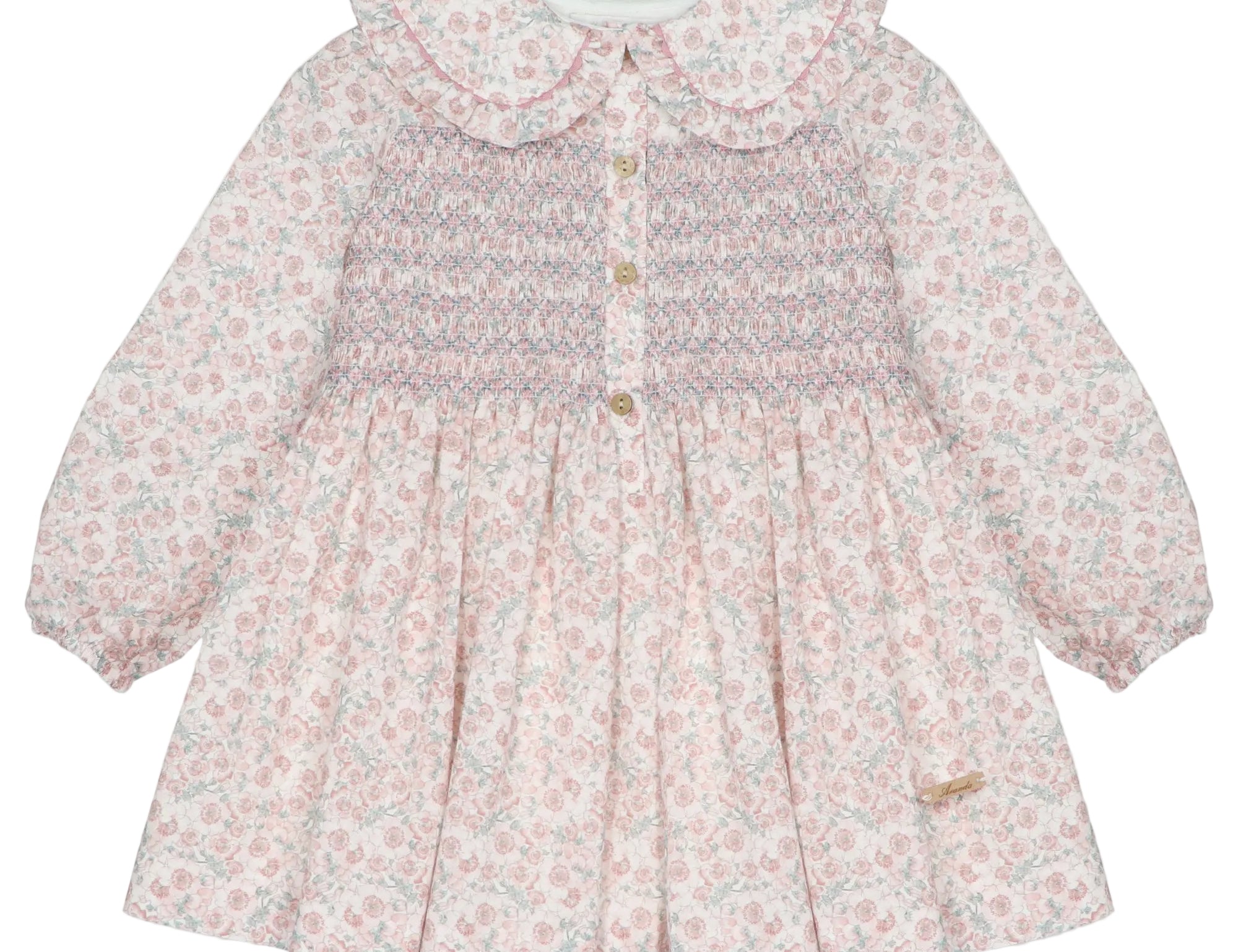 A long-sleeve baby girl's dress with a pink and white floral print, featuring a smocked bodice with gold buttons and a large ruffled Peter Pan collar.