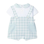 Children's outfit with checkered romper and white shirt on a light gray background