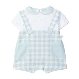 Children's outfit with checkered romper and white shirt on a light gray background