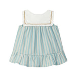 Children's dress with striped skirt and white top on a light gray background