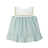 Children's dress with striped skirt and white top on a light gray background
