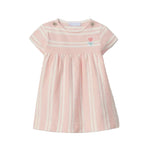 Pink and white striped dress with a small flower design on a light gray background