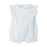 White baby dress with blue floral pattern on a light gray background