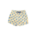 Yellow swim shorts with blue whale pattern on a white background