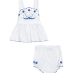 White baby dress with blue floral embroidery on a white background