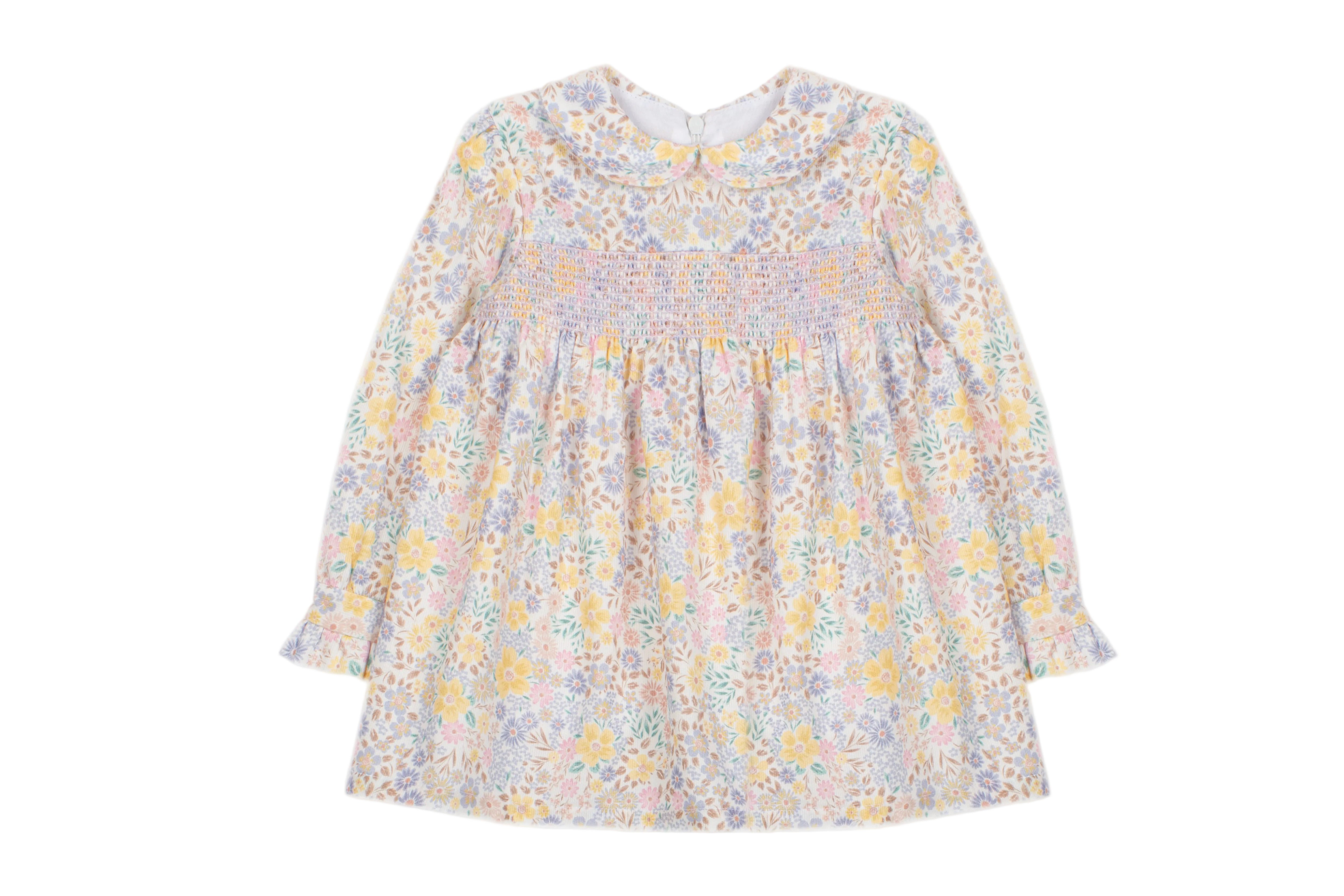 A long-sleeve baby dress with a delicate pastel floral and paisley pattern in yellow, purple, and blue on a white base, featuring a smocked bodice and gathered skirt.