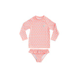 Pink children's swimsuit with white floral pattern on a light gray background